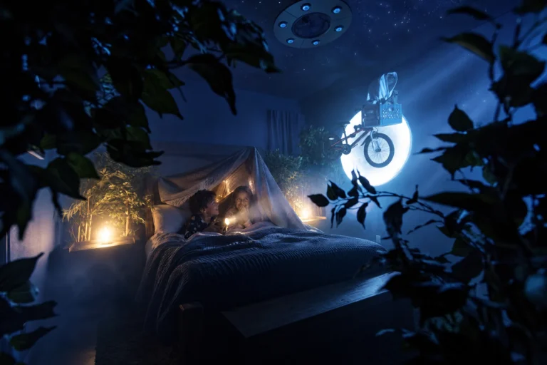 Kids camp out in a blanket fort among the leaves and moonlight of The Extra-TerRestful Suite at Electronic Ice Castle