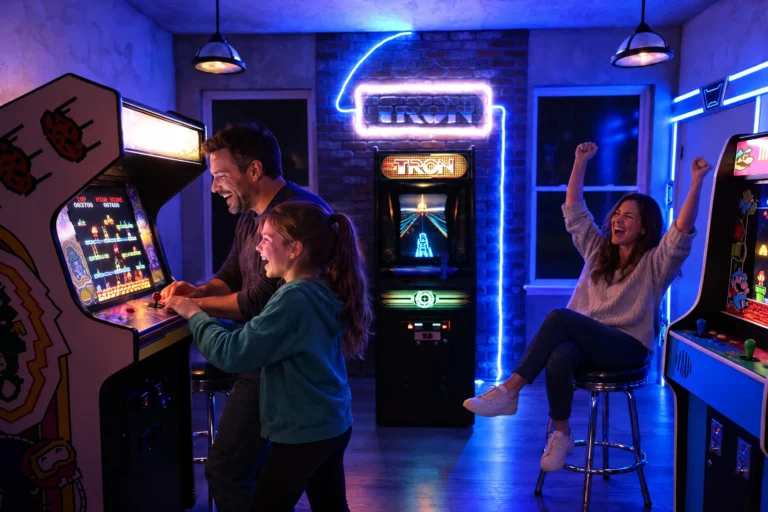 A dad and daughter play an arcade game while mom cheers in Flynn's Arcade at Electronic Ice Castle