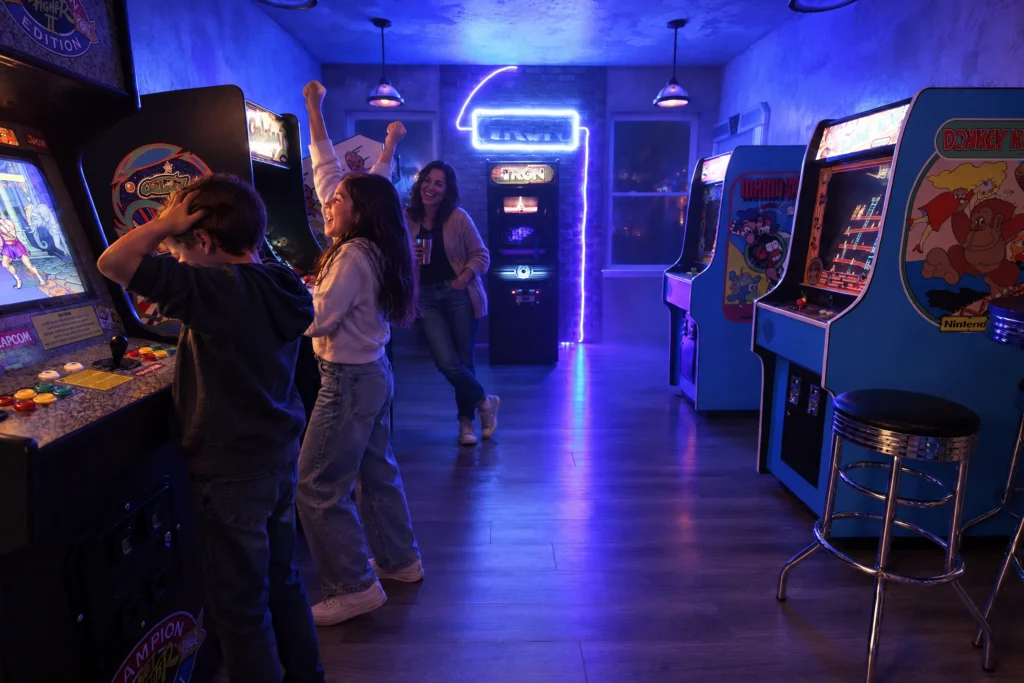 A girl celebrates a win in Flynn's Arcade at The Electronic Ice Castle