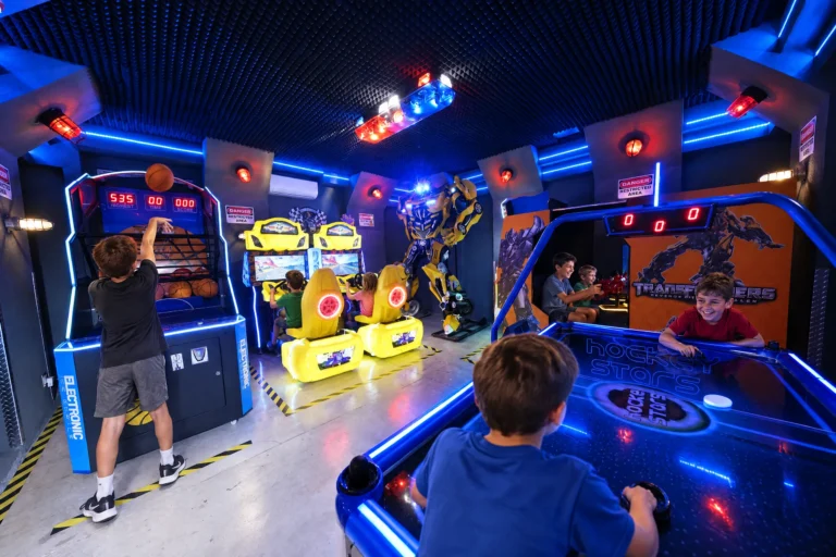 Kids shoot hoops and play air hockey with every station busy in the Robot Game Room at Electronic Ice Castle