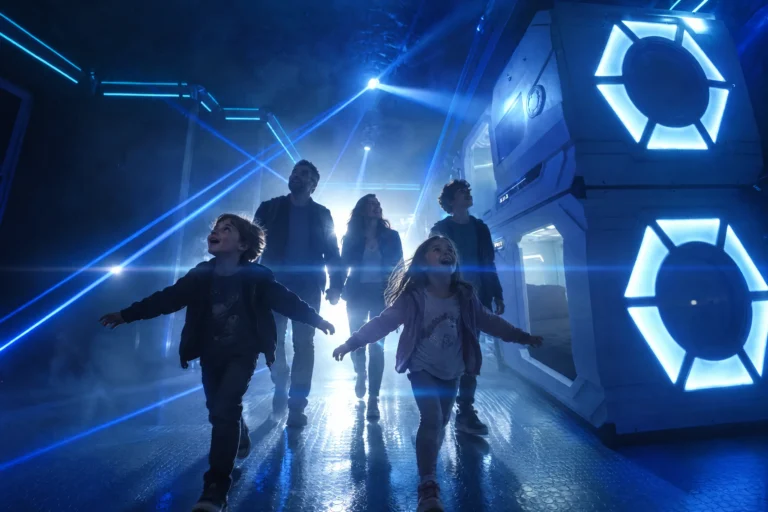A family walks into the laser-lit corridor of The Grid "The Secret Suite" at Electronic Ice Castle