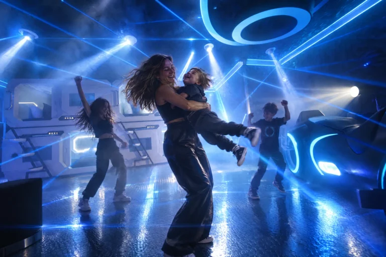 A mom spins her toddler as the kids dance under lasers in The Grid "The Secret Suite" at Electronic Ice Castle
