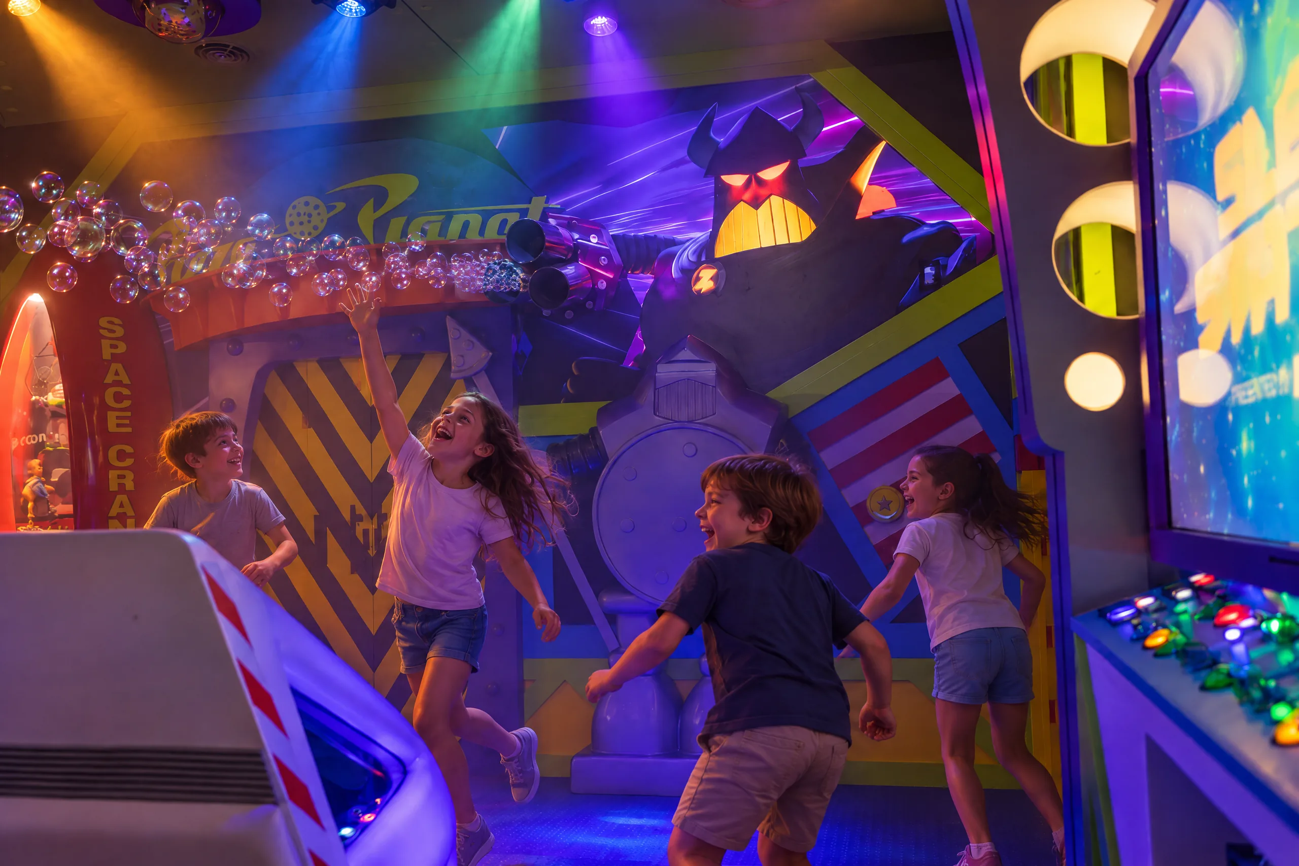 Kids chase a stream of bubbles through Buzz's Sleep Station