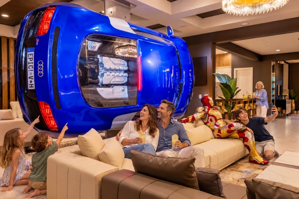 Kids point up at the blue sports car on the living room wall while their teen brother takes a selfie with the armored statue at The Iron Mansion